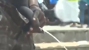 Indian Man With Thick, Flaccid Cock Pees in Public While Chatting on Cell.